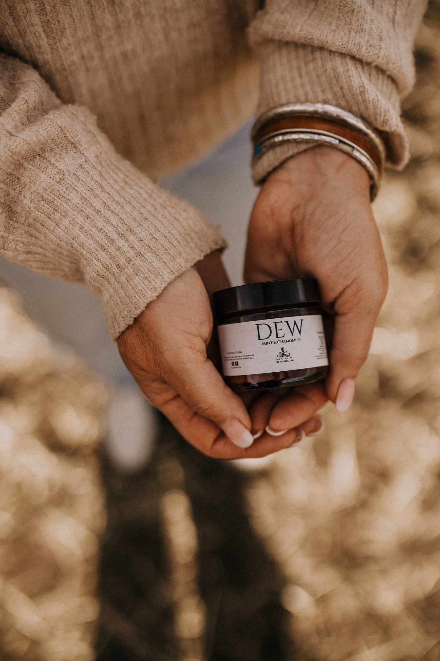 Till & Tallow Dew Aloe After Sun Bam in hands, handcrafted in Alberta.