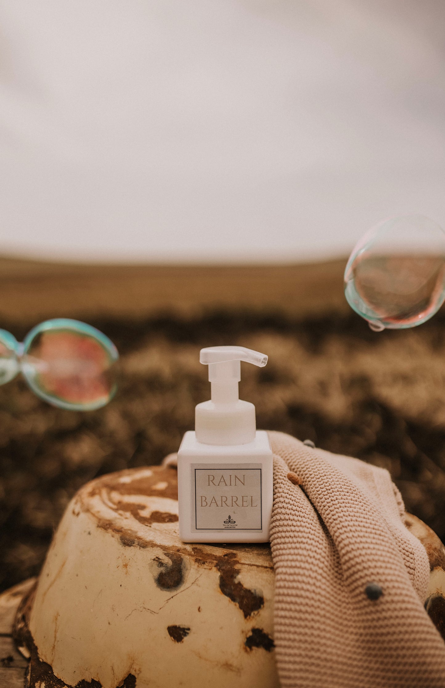 Till & Tallow Rain Barrel Foaming Baby Soap outdoors with bubbles, handcrafted in Alberta.