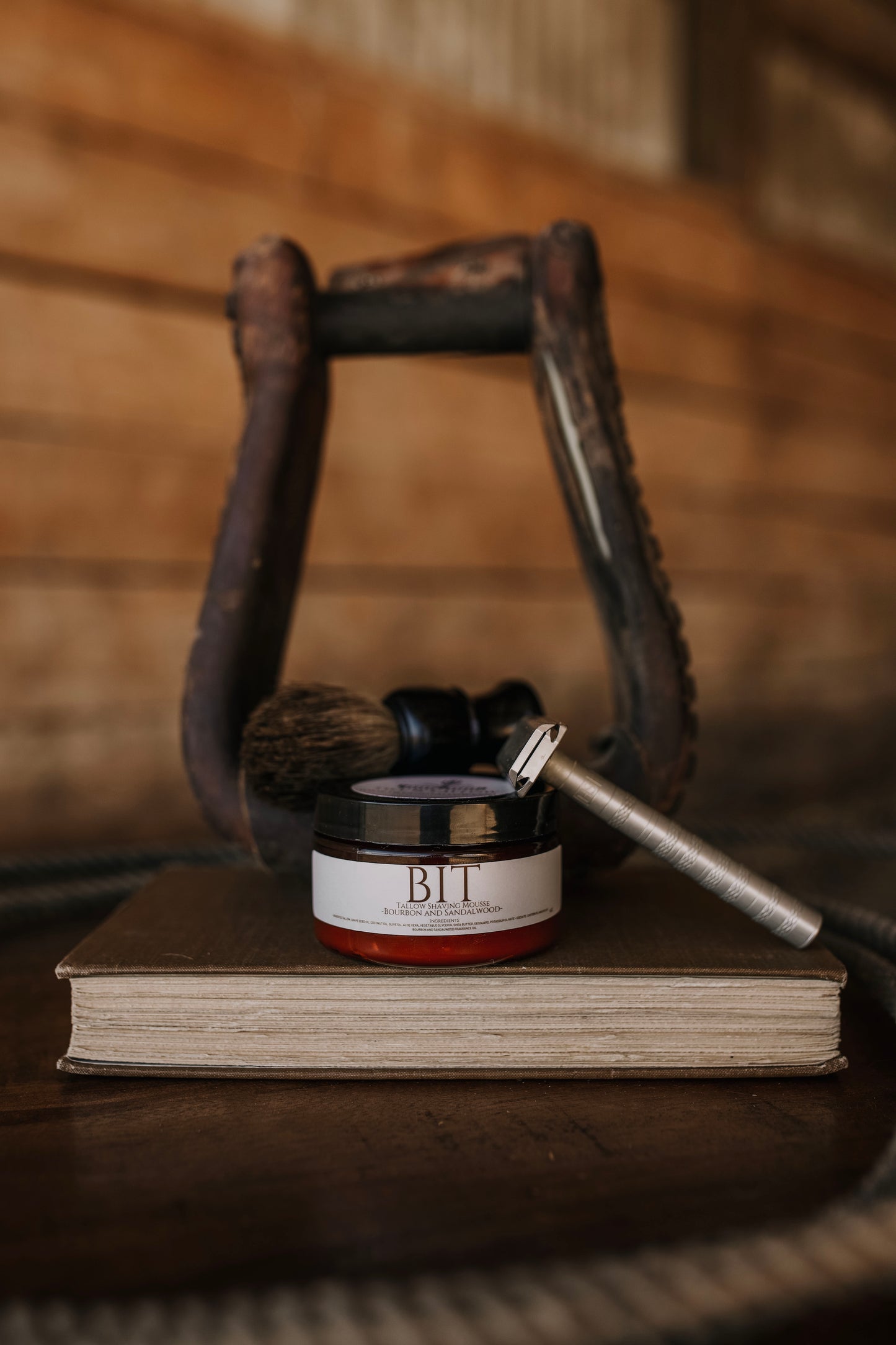 Jar of Bilt on a book with a horse bridle in the background