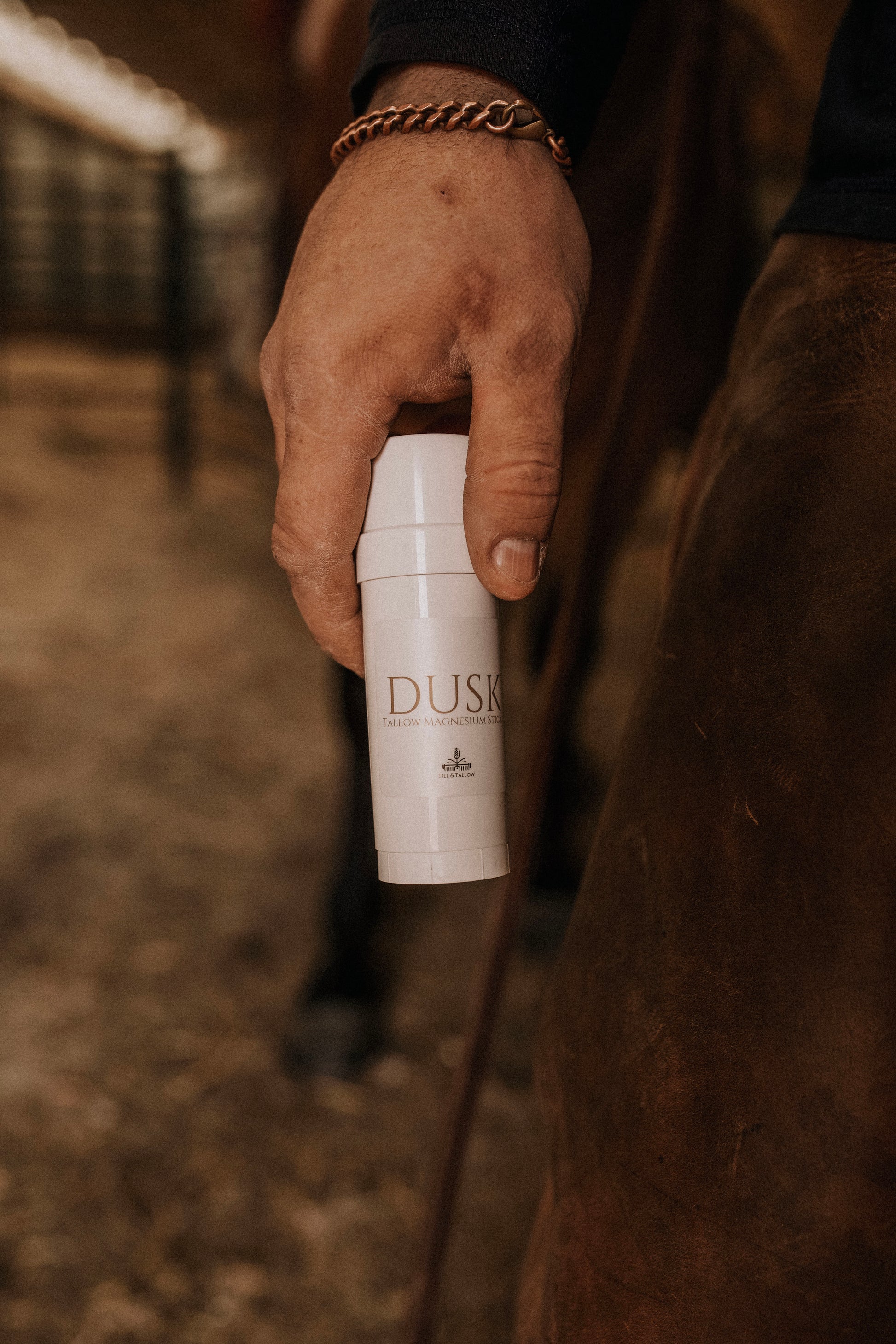 Hand holding Dusk Magnesium tallow stick for natural muscle relief and sleep support by till and tallow, Alberta