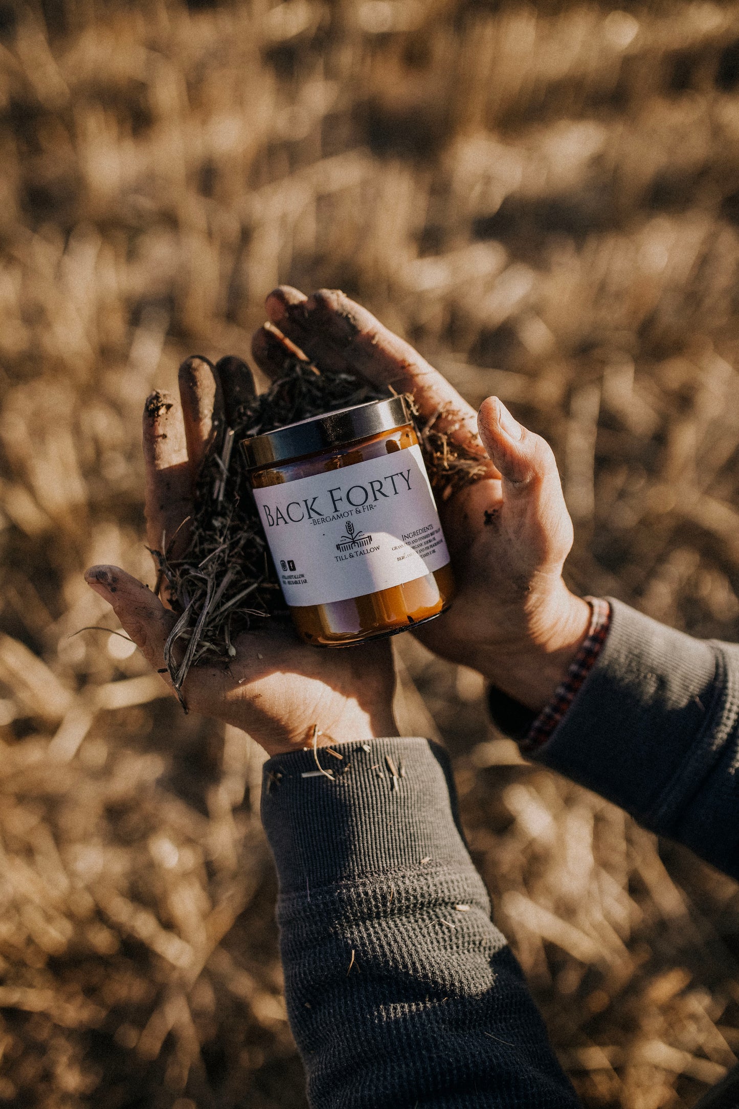 Till & Tallow Back Forty Body Butter in Dirty Farmer hands, handcrafted in Alberta.
