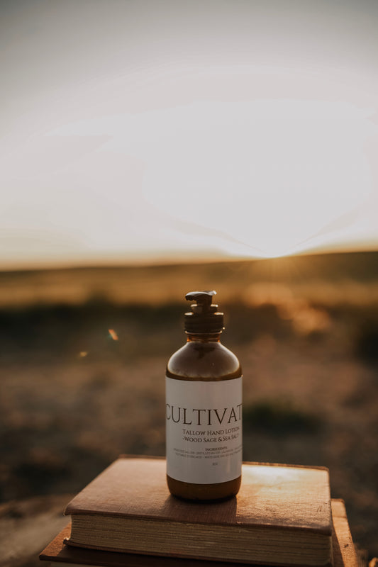 Till & Tallow Cultivated Pump Lotion on wooden book outdoors, handcrafted in Alberta.