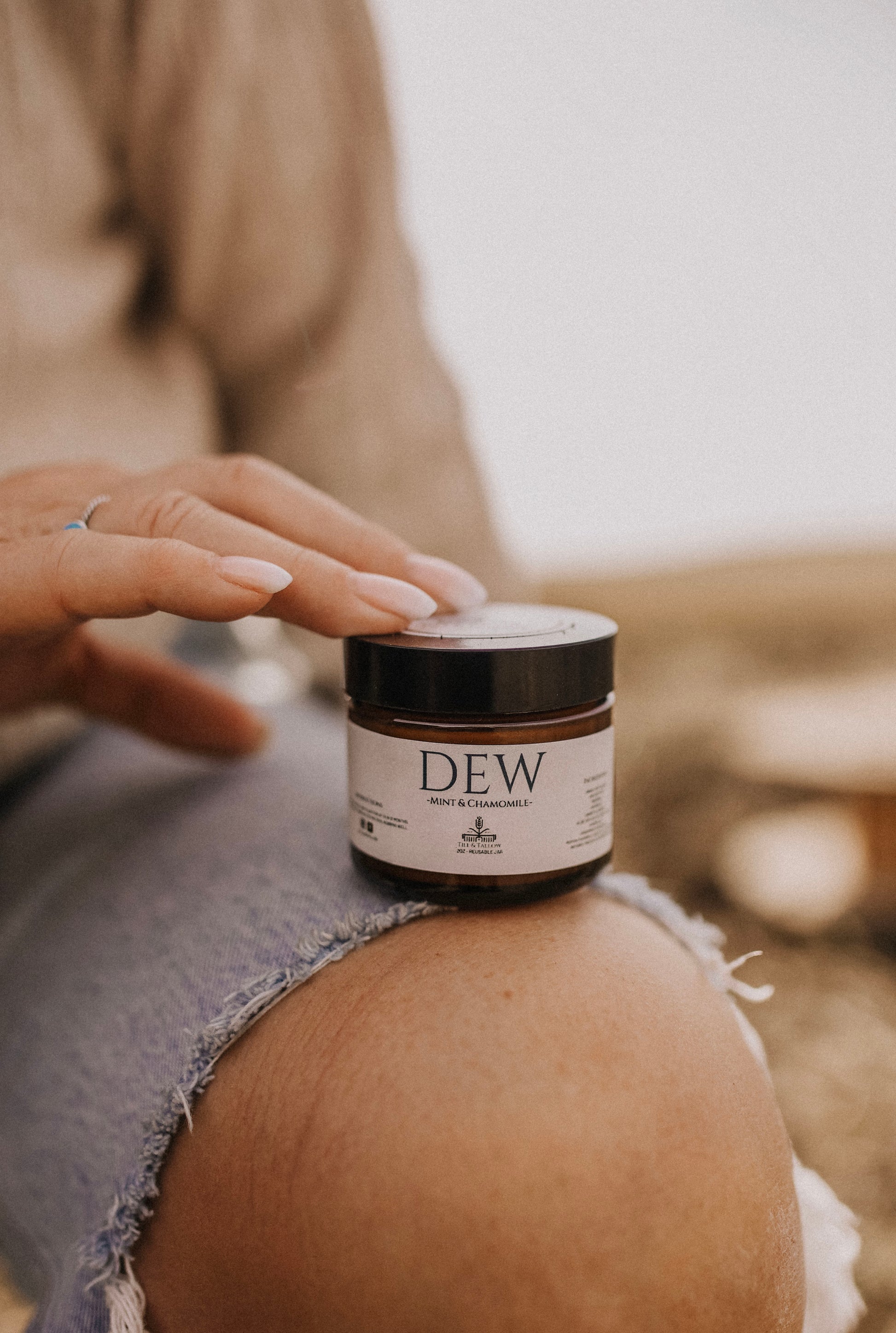 Till & Tallow Dew Aloe After Sun Balm on knee, handcrafted in Alberta