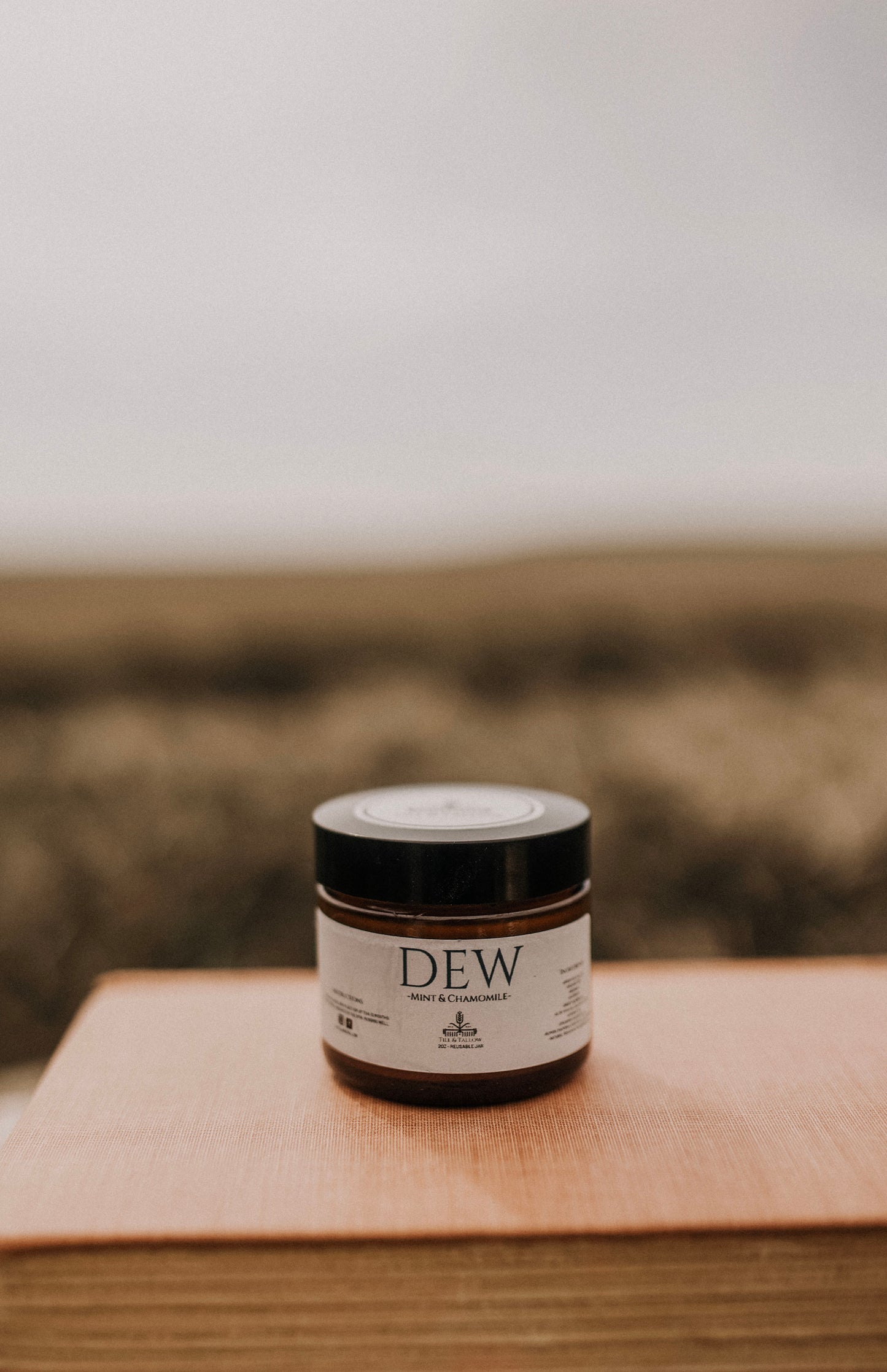 Till & Tallow Dew Aloe After Sun Balm on book, handcrafted in Alberta.