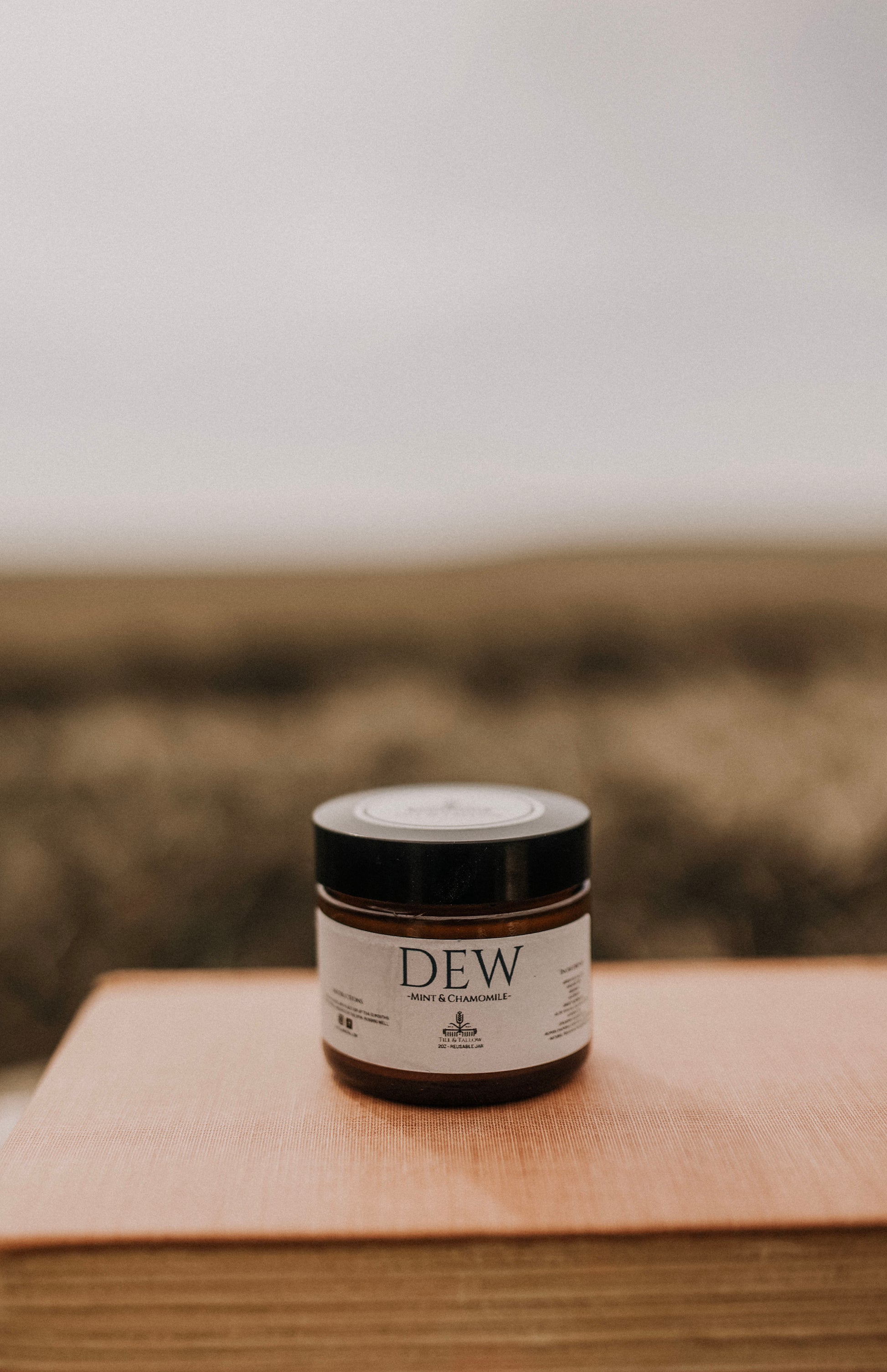 Till & Tallow Dew Aloe After Sun Balm on book, handcrafted in Alberta.