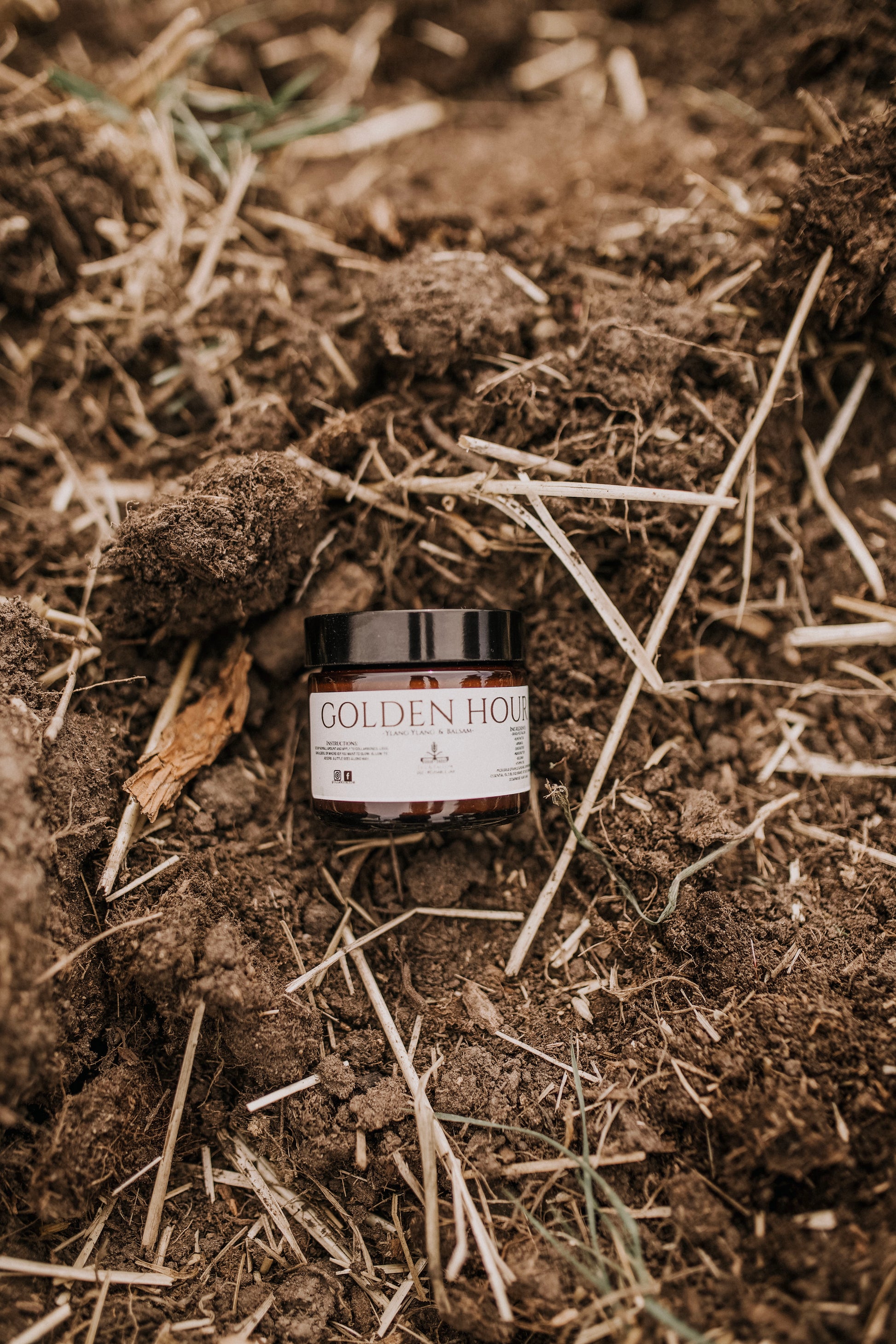 Till & Tallow Golden Hour Body Shimmer on soil, handcrafted in Alberta.