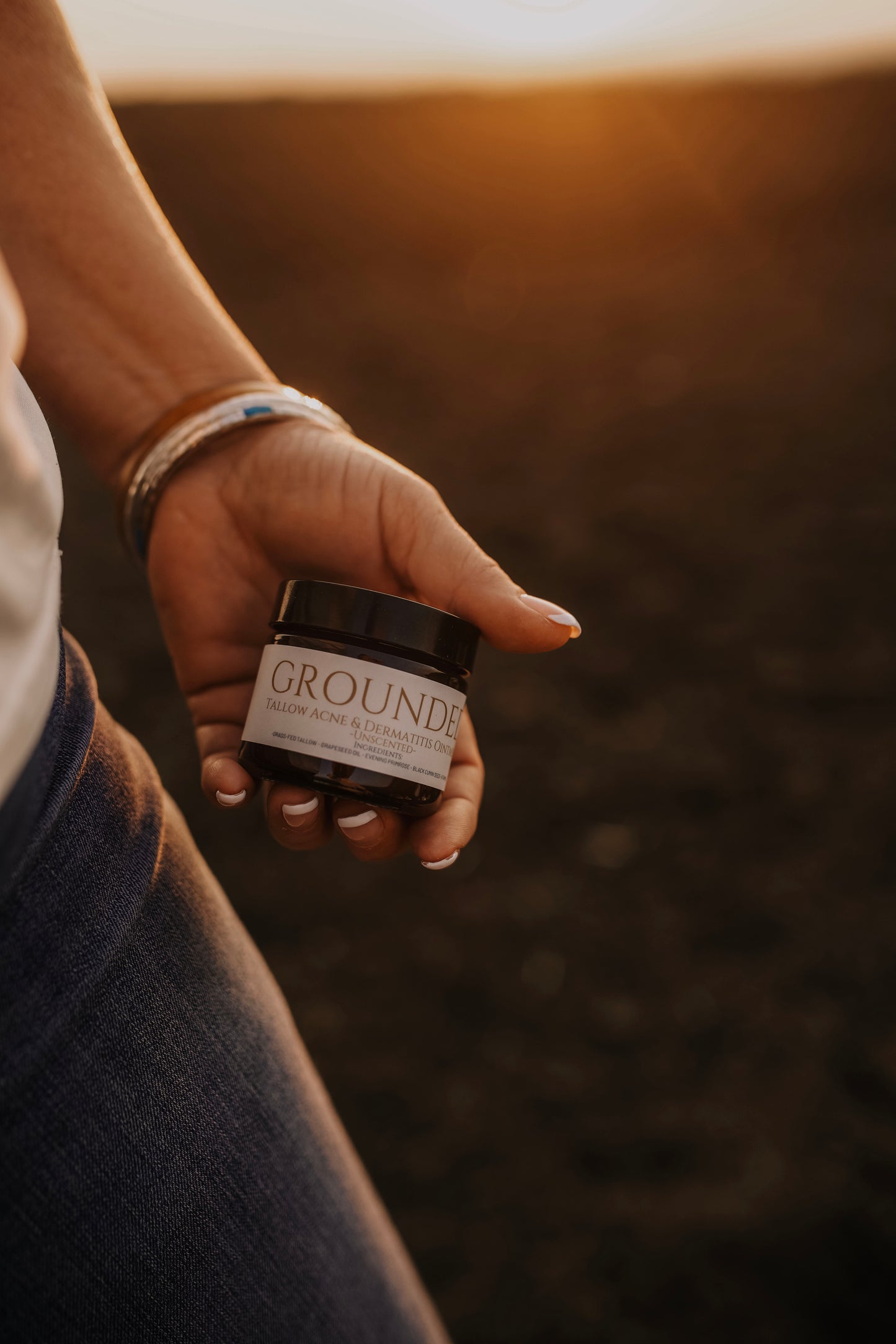 Till & Tallow Grounded Face Balm in hand, handcrafted in Alberta