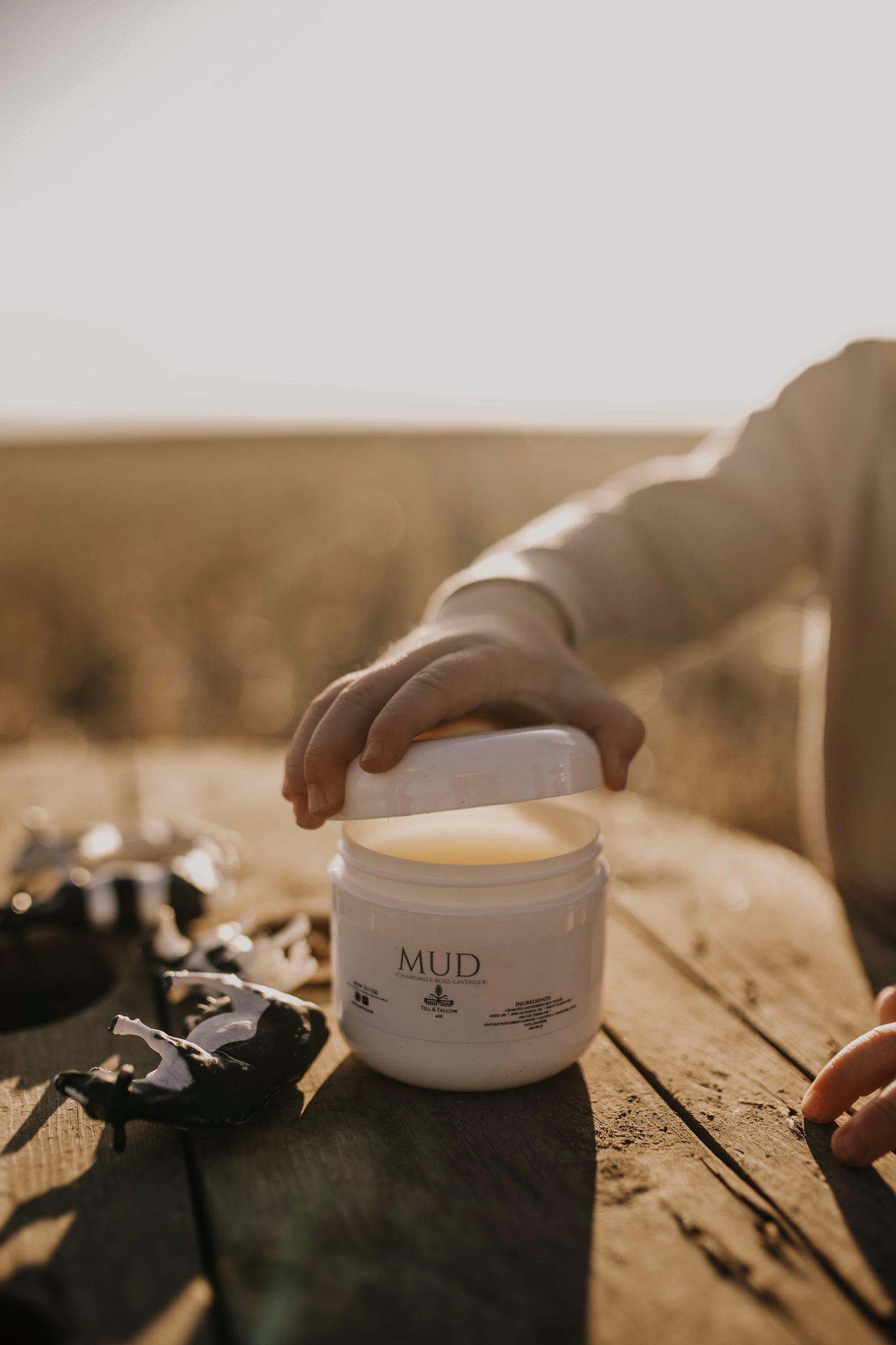 Till & Tallow Mud Baby Bum Balm open lid, handcrafted in Alberta.