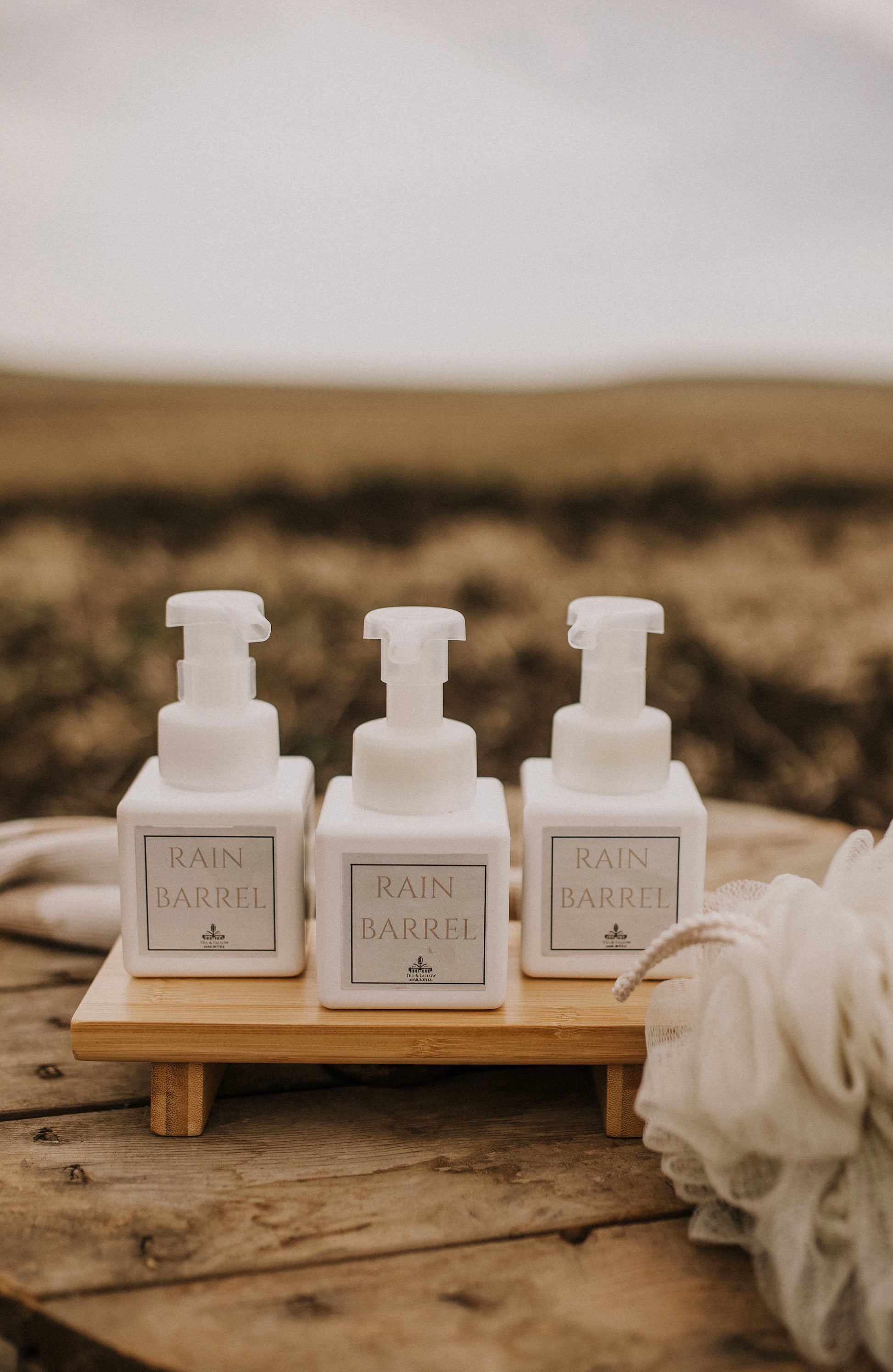 Till & Tallow Rain Barrel Foaming Baby Soap, three bottles on wood shelf, handcrafted in Alberta.