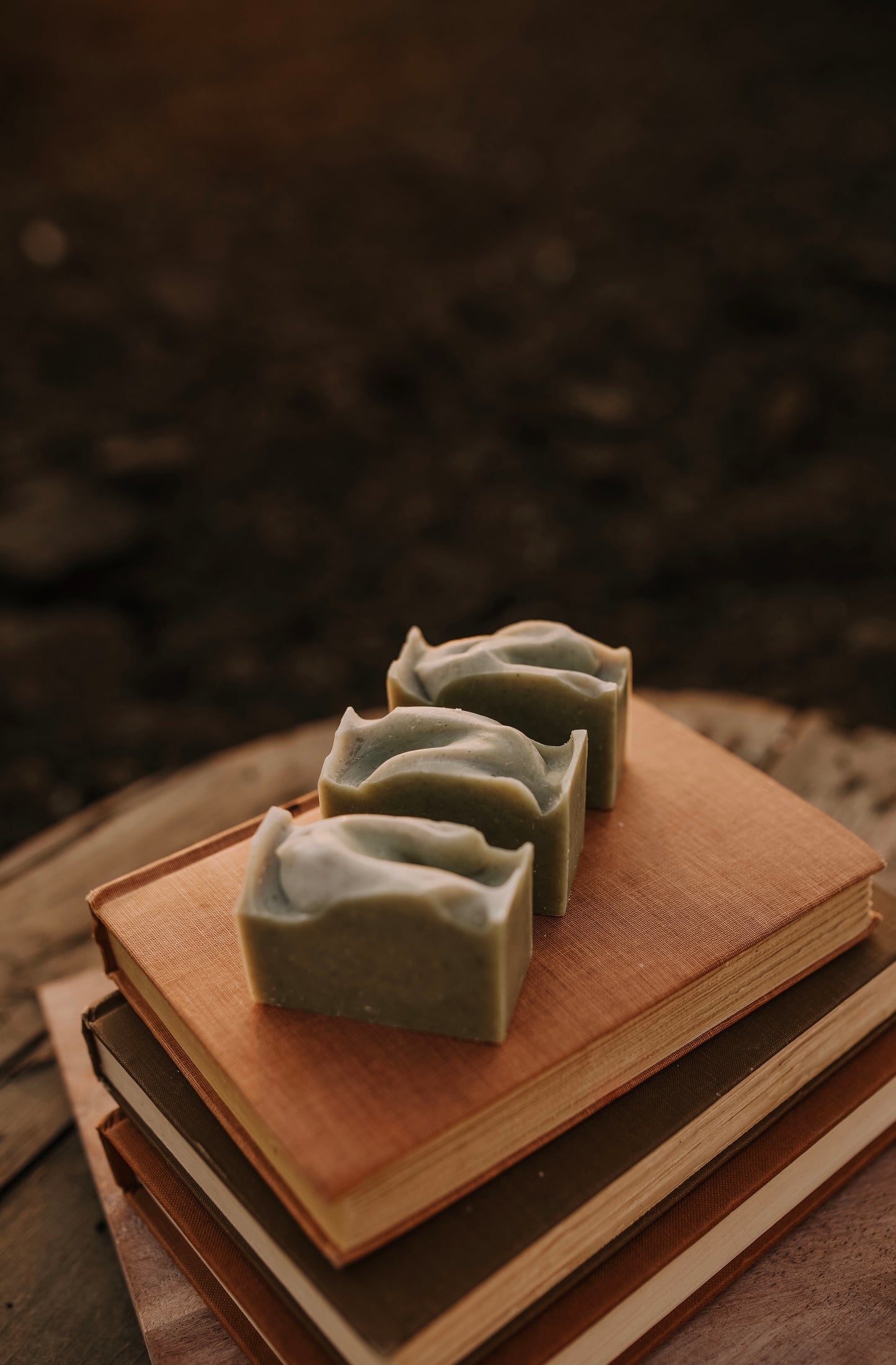 Till & Tallow Saffron & Cedar Tallow Bar Soap on books, handcrafted in Alberta